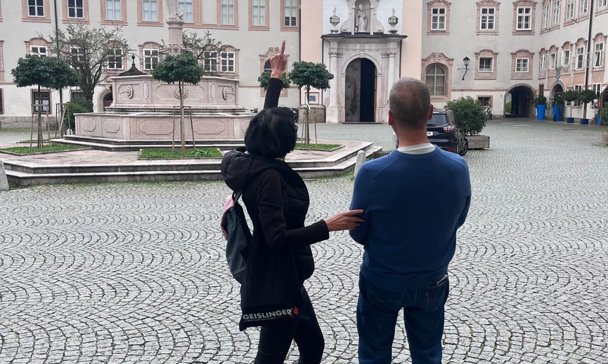 salzburg-cathedral-square-domquartier-walking-tour Tourists exploring Salzburg Tours Cathedral Square (Domplatz) with a view of the Hohensalzburg Fortress. A highlight of the Salzburg Old Town walking tour.
