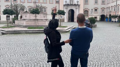 Local expert Annabelle Blanc pointing out historic architectural details to a guest during private sightseeing Salzburg tours in the city center.