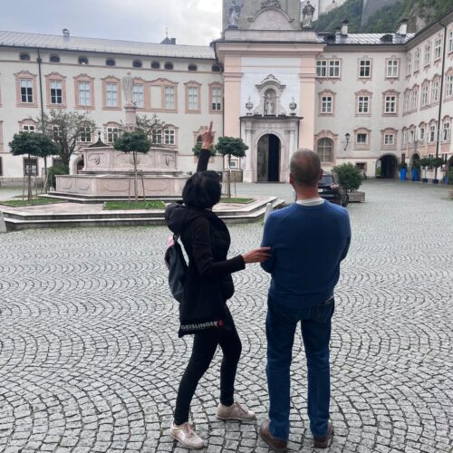 Tourists exploring Salzburg Tours Cathedral Square (Domplatz) with a view of the Hohensalzburg Fortress. A highlight of the Salzburg Old Town walking tour.
