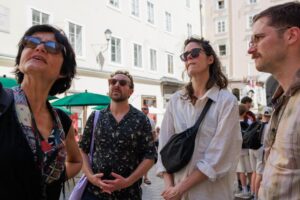 State-certified guide Annabelle Blanc leading an engaging historical sightseeing walk during our Food Tours in Salzburg.