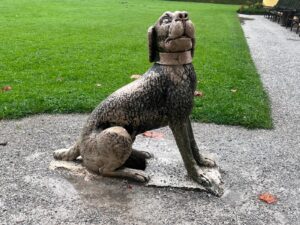 A playful stone dog statue located in the Wasserspiele, a thrilling highlight of our Private Hellbrunn Palace & Trick Fountains Tour.