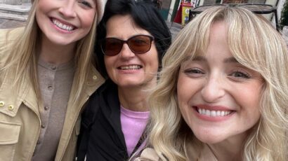 Certified guide Annabelle Blanc taking a selfie with two happy tourists in front of a traditional pharmacy building during a premium salzburg guided walking tour in Salzburg, Austria.